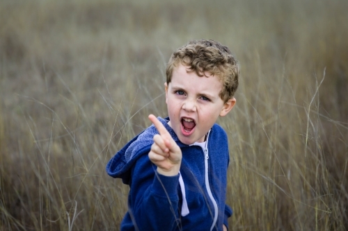 Boy with mouth open shaking finger