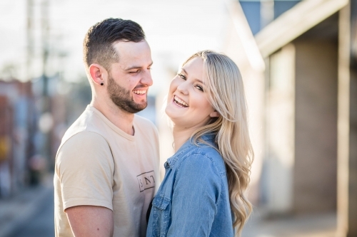 Boyfriend looking at girlfriend laughing - Australian Stock Image