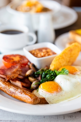 Breakfast dish with fried egg and sausage - Australian Stock Image