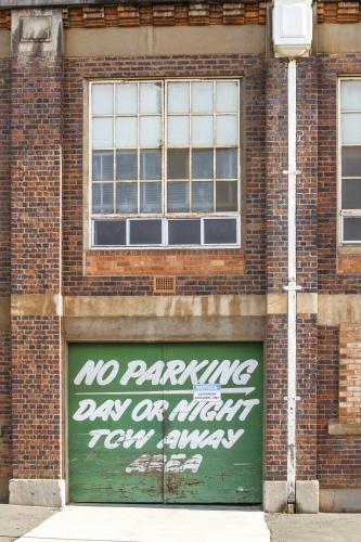 Brick wall and green door of historic factory in Launceston - Australian Stock Image