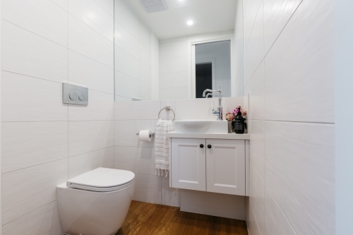 Bright white contemporary powder room in an Australian home - Australian Stock Image