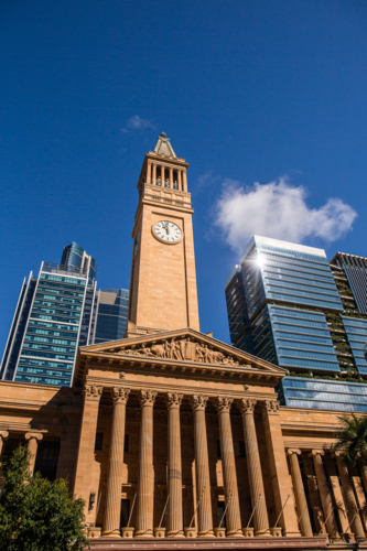 Brisbane city hall historical building and surrounding skyscrapers - Australian Stock Image