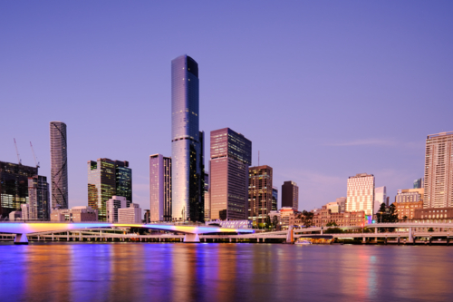 Brisbane City with lights glowing on the Brisbane River - Australian Stock Image