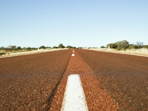 brown bitumen highway in outback