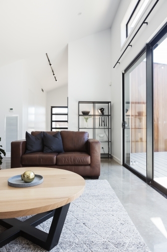 Brown sofa in contemporary styled living room - Australian Stock Image