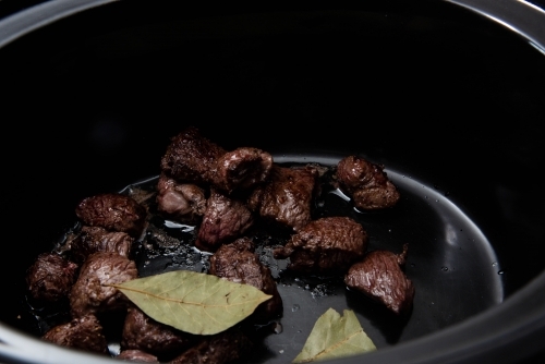 Browned meat in a slow cooker - Australian Stock Image