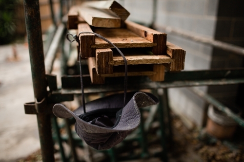 Builders hat hanging from some timber - Australian Stock Image