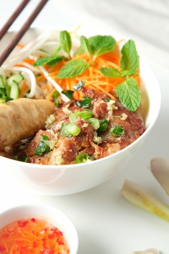 Bun Cha Gio bowl with meat slices topped with fried spring roll. - Australian Stock Image
