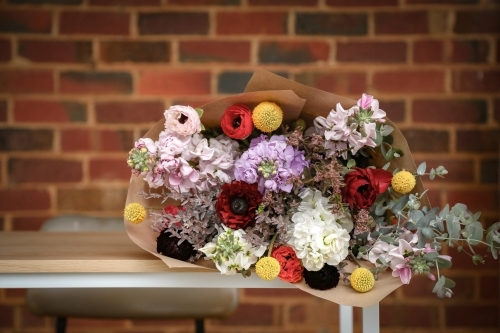 Bunch of cut cottage flowers in rustic country setting - Australian Stock Image