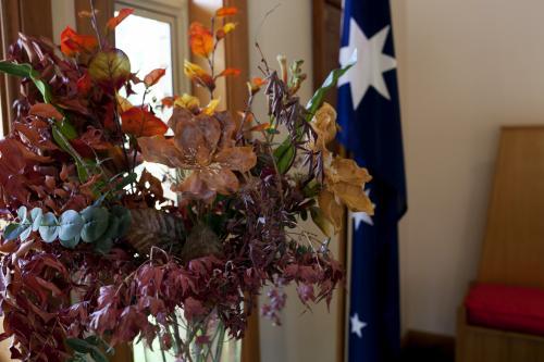 Bunch of flowers with Australian flag hanging in background - Australian Stock Image