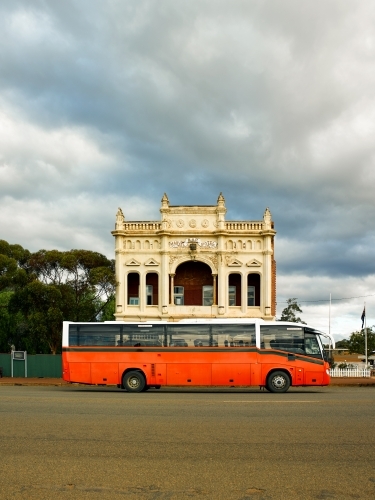 Bus parked in front of heritage building in a remote mining town