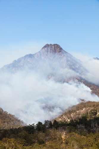 Bushfire smoke from a wildfire surrounds Mt Barney in the Scenic Rim. - Australian Stock Image