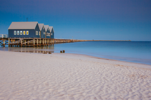 Busselton Jetty shimmers in the early morning in light in Busselton, Western Australia, Australia - Australian Stock Image