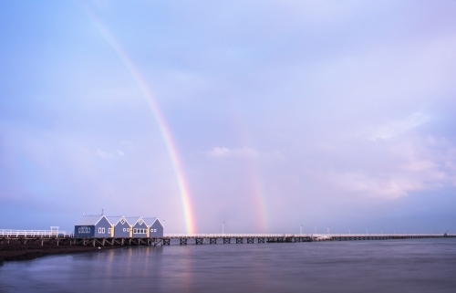 Busselton Jetty with a rainbow leading over it.