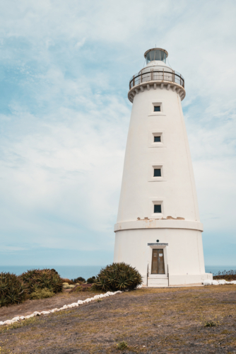 Cape Willoughby active lighthouse viewed against blue sky with clouds on a day, Kangaroo Island - Australian Stock Image