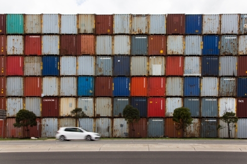 Car in front of colourful shipping containers - Australian Stock Image