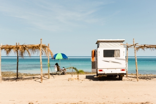 Caravan and shades against ocean horizon - Australian Stock Image