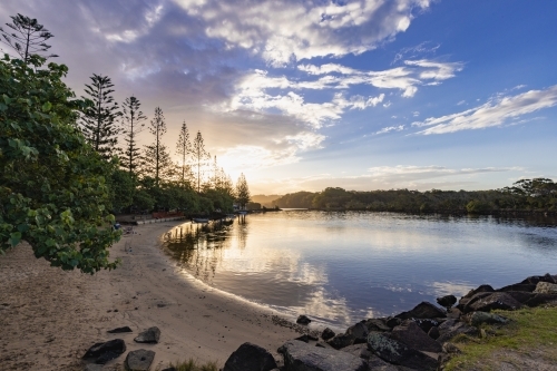 Caravan Park along the Brunswick River at sunset - Australian Stock Image