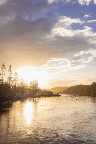 Caravan Park along the Brunswick River at sunset - Australian Stock Image