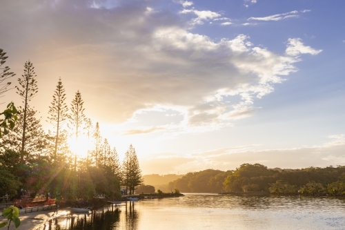 Caravan Park along the Brunswick River at sunset - Australian Stock Image