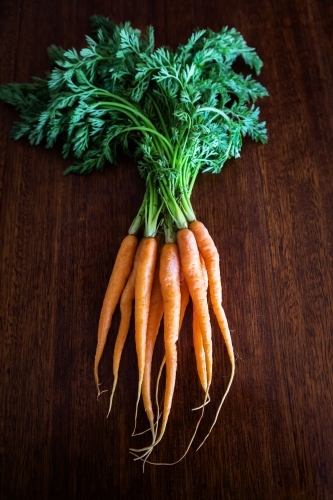 Carrots on a wooden kitchen bench - Australian Stock Image