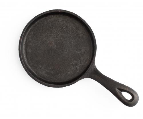 cast iron frying pan on white background - Australian Stock Image