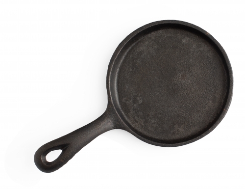 cast iron frying pan on white background - Australian Stock Image