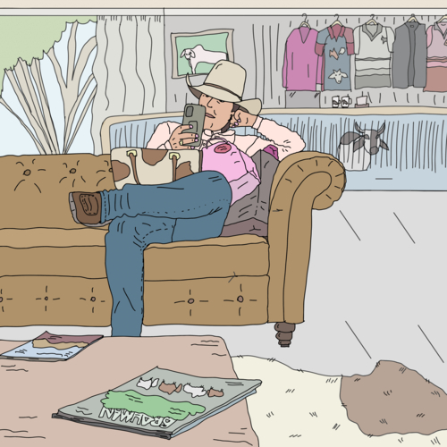 Cattle woman sitting alone in country clothing shop looking at mobile phone - Australian Stock Image