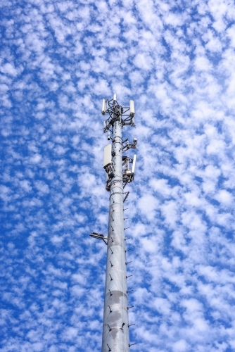 Cell phone telecommunication tower against blue sky and amazing clouds background, Melbourne - Australian Stock Image