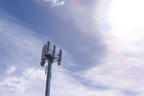 Cell phone telecommunication tower on blue sky and amazing clouds background, Melbourne - Australian Stock Image