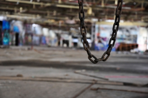 Chain in abandoned warehouse - Australian Stock Image