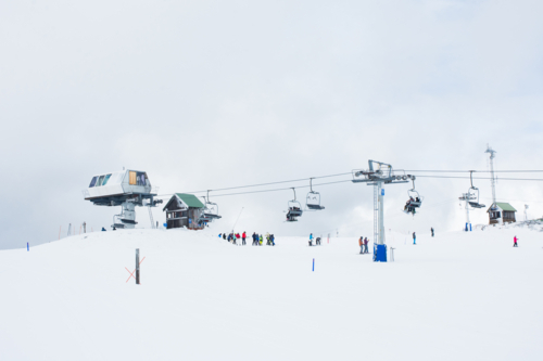 Chairlift in the snow with lots of skiers - Australian Stock Image
