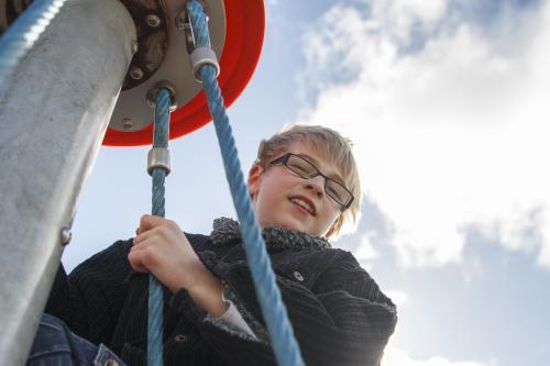 Child at top of playground equipment - Australian Stock Image