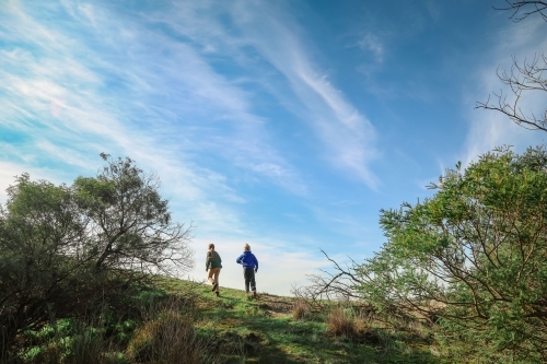 Children exploring on a morning adventure under bright blue sky - Australian Stock Image