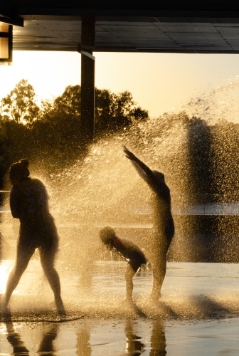 Children playing in a playground water jets at Eastshores recreation area, in Gladstone, Queensland - Australian Stock Image