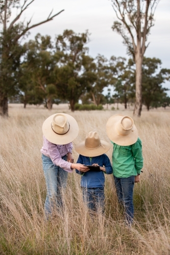 Children using an ipad on farm - Australian Stock Image