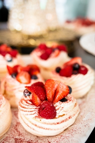 Christmas meringues with raspberry, strawberry, blueberry and cream - Australian Stock Image