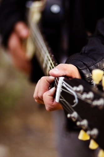 Close up detail of guitar strings and neck - Australian Stock Image