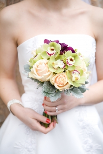 Close up of a bride holding a bouquet of flowers - Australian Stock Image