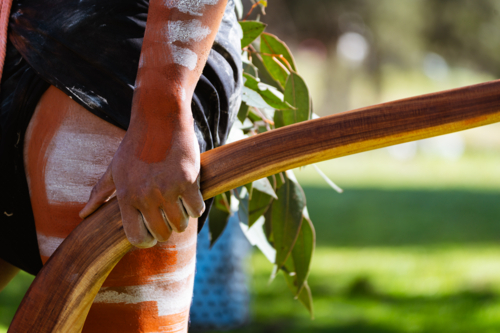 Close up of aboriginal male holding boomerang - Australian Stock Image