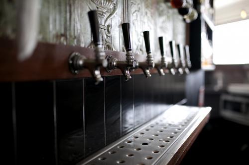 Close up of beer taps at local craft beer bar