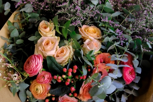 Close up of colourful floral arrangement with native leaves - Australian Stock Image