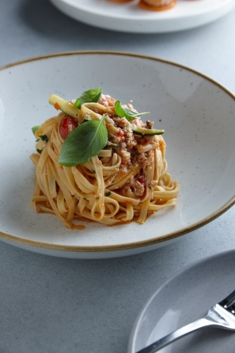 Close up of fresh pasta dish on table - Australian Stock Image