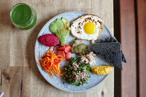 Close-up of healthy vegetarian meal on wooden table - Australian Stock Image