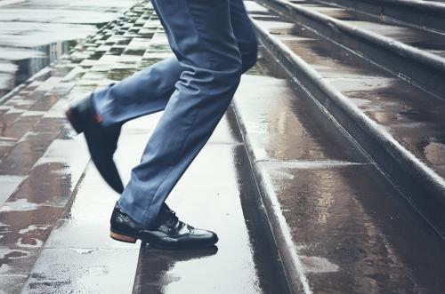 Close up of man's legs running up parliament steps - Australian Stock Image