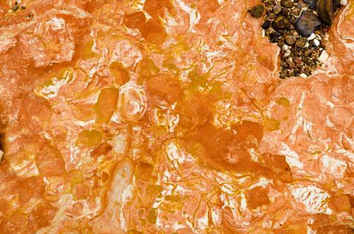 Close up of marbled rock with orange colours - Australian Stock Image