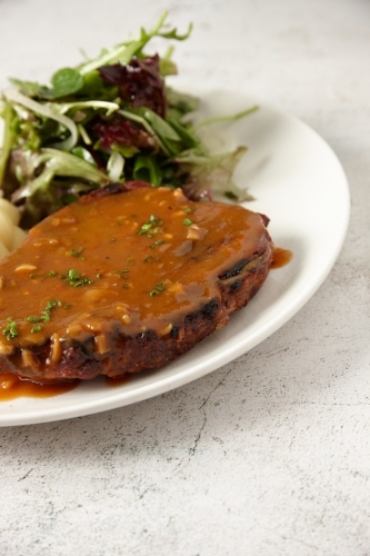 Close up of steak with green salad - Australian Stock Image