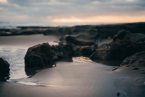 Close up of the sand and rocks at sunset - Australian Stock Image