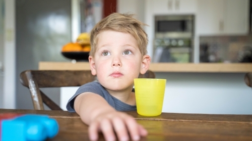 Close up of toddler with arm outstretched - Australian Stock Image