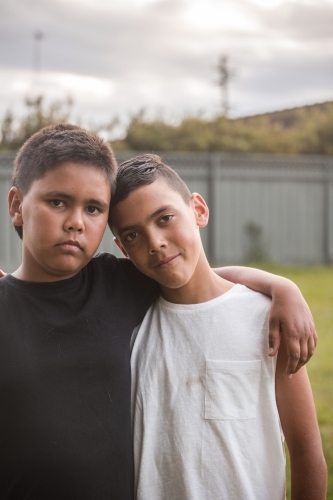 Close up of two aboriginal boys looking at the camera - Australian Stock Image